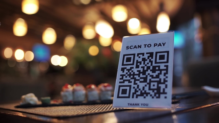 Scanning QR code with smart phone. The woman reads the bar code using the application on the smartphone in cafe Royalty-Free Stock Footage #1062460006