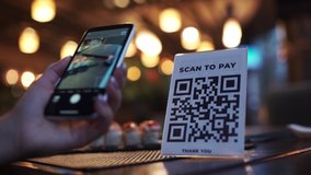 Scanning QR code with smart phone. The woman reads the bar code using the application on the smartphone in cafe - Powered by Shutterstock - Get 15% off with code: PIKWIZARD15