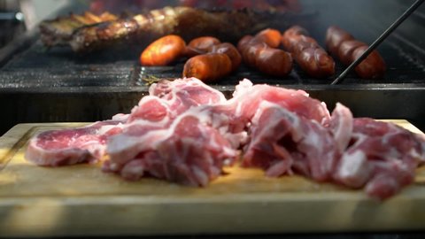 Slow motion chef put delicious red pepper and a ribs pork to barbecue grill. Close up of cooked grilled meat and vegetables for BBQ at garden home at holiday vacations. Man cooking in Spain- 