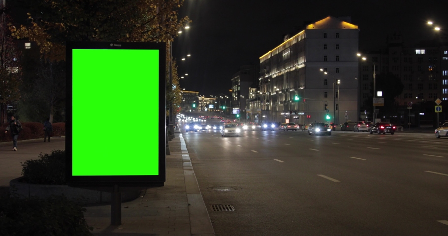 Billboard with a green screen on the street, next to the road, in the dark, time-lapse, accelerated shooting. Use for installation. | Shutterstock HD Video #1062469288