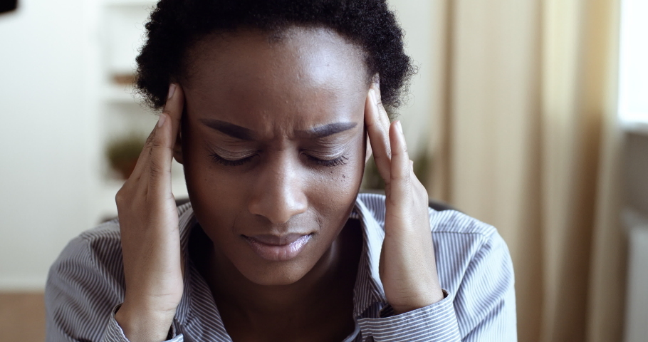Face of upset african woman ethnic girl feeling stress grief suffering from headache migraine symptoms worried about loneliness divorce learns bad news about unnatural pregnancy or financial problems | Shutterstock HD Video #1062479011