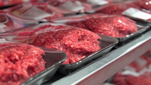 raw minced meat on the shelves of a hypermarket close-up. sale of fresh meat