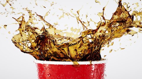 Close-up Shot Golden Liquid Splash with Drops Ice Cubes in a Red Drink. 3d Art Crown Splashing Cool Fizzy Lemonade Rum Cola with Dripping Surface. Animation of Dark Liquid Splash on White Backdrop 4k