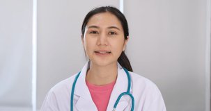 Young female doctor or physician wear white uniform video call with patient. Asian Doctor looking camera and talking. concept health application for doctor and patient.