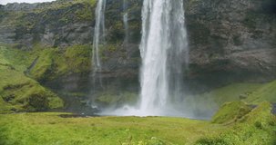 Closeup of Seljalandfoss waterfall Iceland in rainy moody weather.