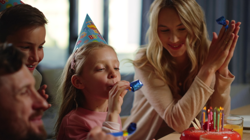 Cheerful family having online party at home. Happy parents and children celebrating birthday via internet indoors. Smiling mother, father and kids enjoying virtual greetings inside. Royalty-Free Stock Footage #1062499393