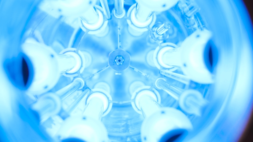 UV water purifier. Media. Close-up of bright ultraviolet flasks in device. UV device with blue light for cleaning water from chlorine. Futuristic UV flasks | Shutterstock HD Video #1062508768