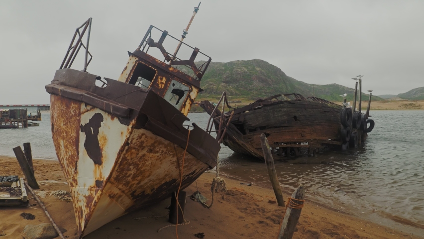 Ship cemetery on the shore of the Barents sea in the far Northern village of Teriberka on the Kola Peninsula, Russia. Smooth camera movement.