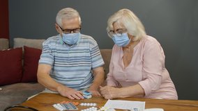 Senior couple grandfather and grandmother measuring, monitoring oxygen saturation with digital pulse oximeter at home. Elderly woman and man in medical masks. Coronavirus, Covid-19 quarantine lockdown - Powered by Shutterstock - Get 15% off with code: PIKWIZARD15