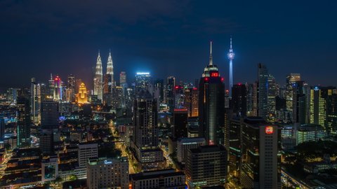 Kuala Lumpur, Malaysia - April 26: Day to night time lapse view of Kuala Lumpur skyline including architectural landmarks Petronas Towers and KL Tower in Kuala Lumpur, Malaysia. 