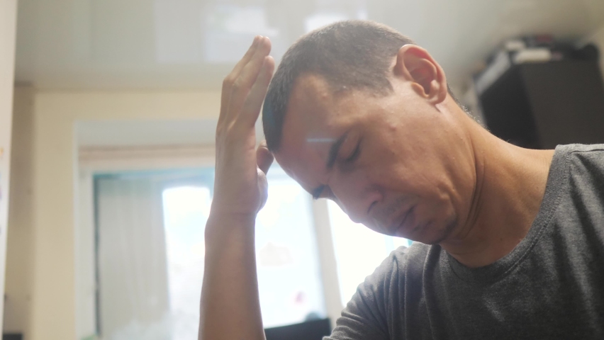 Man tired depression at work indoors is sick with coronavirus. sick senior. tired man has a headache. dad got covid 19 tired depression | Shutterstock HD Video #1062521953