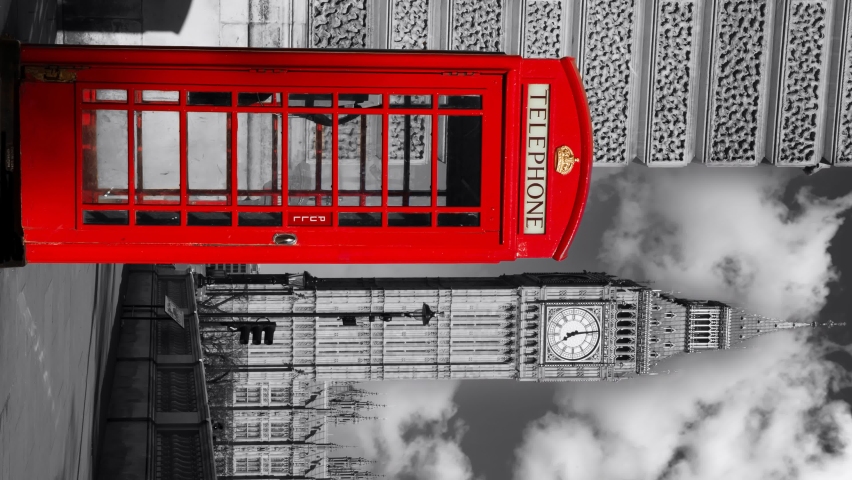 A red London phone box with a black and white background of the UK Houses of Parliament with moving clouds