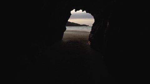 walk from cave to beach during sunset gimbal shot