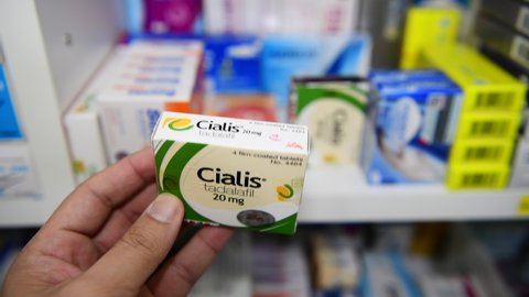 BANGKOK ,THAILAND - JAN 20 2020: Cialis 5 mg. new strength in hand on drugstore Bangkok. Cialis was originally developed by Eli Lilly as an erectile dysfunction drug.
