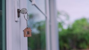 The house key for unlocking a new house is plugged into the white door. The keychain is moving after the wind blows. house for sell concept. - Powered by Shutterstock - Get 15% off with code: PIKWIZARD15