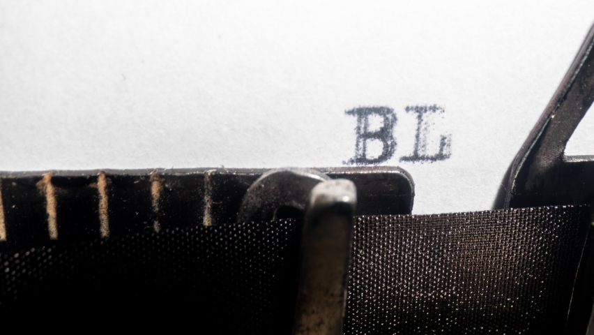 Close up of an old fashioned typewriter typing blag blah blah 