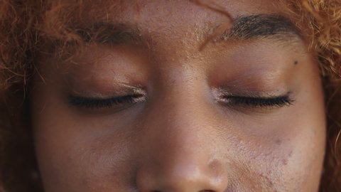 Close up, opening eyes. African american black woman opening her eyes. High quality 4k footage