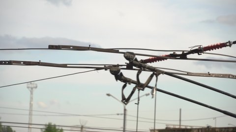 Trolleybus wires close-up, passing contacts horns
