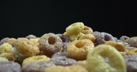 Cereal rainbow hoops. Closeup shot of healthy multicolored cereal. Zoom in.