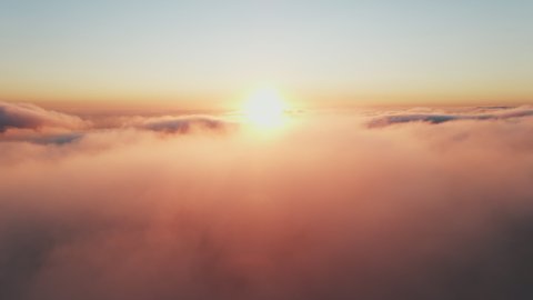 Moving white clouds blue sky scenic aerial view sunset. Sun is hidden behind clouds at fog. Drone flies high back in blue sky through fluffy clouds in evening at golden sun summer. Relax. Nature