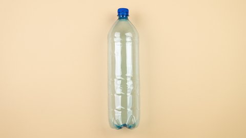 Plastic bottles with stainless steel refillable bottle. The plastic alternative. Stop motion, the plastic bottle in motion is replaced by a stainless steel bottle.