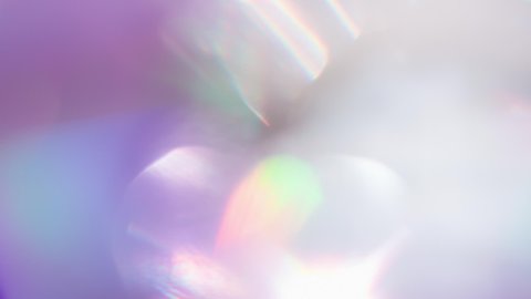 Optical Refraction in Violet Tones. Loop. The light passes through the facets of a slowly rotating diamond and creates repetitive sparkling highlights and rainbow colors