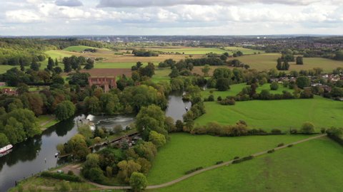 4k aerial footage The River Thames flows through countryside on the outskirts of Reading, Berkshire, UK