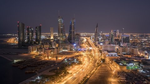 MANAMA , BAHRAIN - NOVEMBER 18, 2020: 4K Day to Night Aerial time lapse of Bahrain's tallest iconic buildings Bahrain World trade center and Bahrain Financial Harbour, Manama, Bahrain