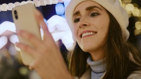 Close up video of woman browsing phone  and drinking mulled wine.  Shot with RED helium camera in 8K.