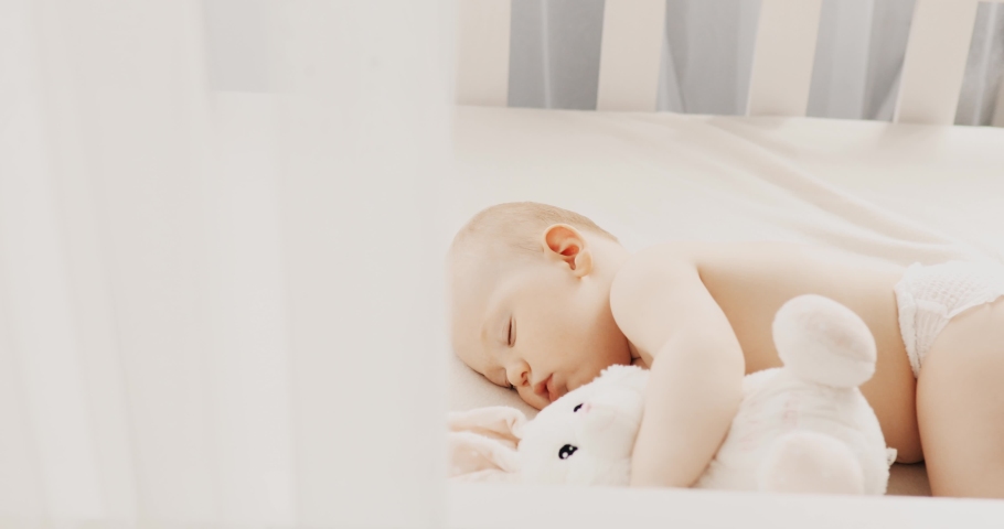  small child sleeps at home in a crib | Shutterstock HD Video #1062552598