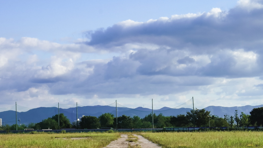Grass playground view with moving clouds

