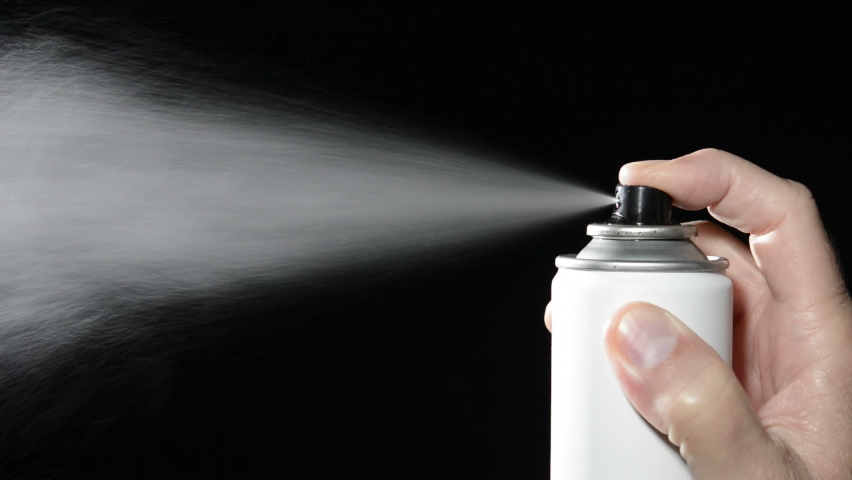 A man depresses the button on an aerosol spray can, dispensing chemicals into the atmosphere | Shutterstock HD Video #1062560065