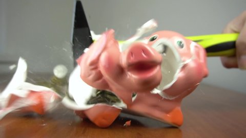 The piggy bank is smashed with a hammer.The piggy bank shatters into pieces, coins fly apart.Inside the room