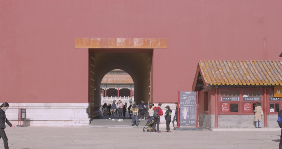 Female in Black clothing walked passed Palace gate