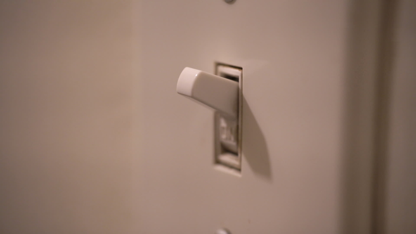 Person turns light switch on and off. Close up of finger. | Shutterstock HD Video #1062578353