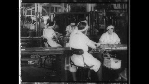 1920s New York City. Female Factory Workers at work on the Assembly Line. 4K Overscan of 16mm Film