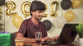 Young man partying during new year or Christmas celebration video call on laptop - concept of distant holyday celebration due to coronavirus or covid-19 pandemic