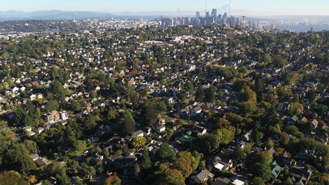 Aerial / drone footage of Northlake, Queen Anne, Westlake, downtown Seattle, Mt. Rainier with upscale, affluent neighborhoods uptown by Puget Sound, in Seattle, Washington