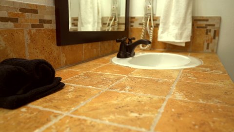 Beautiful bathroom interior design of vanity cabinet, traditional tile countertop. Bathroom interior tiles design on counter and backsplash.