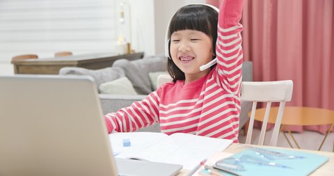 asian girl is using protractor and learning math online through laptop with headset at home