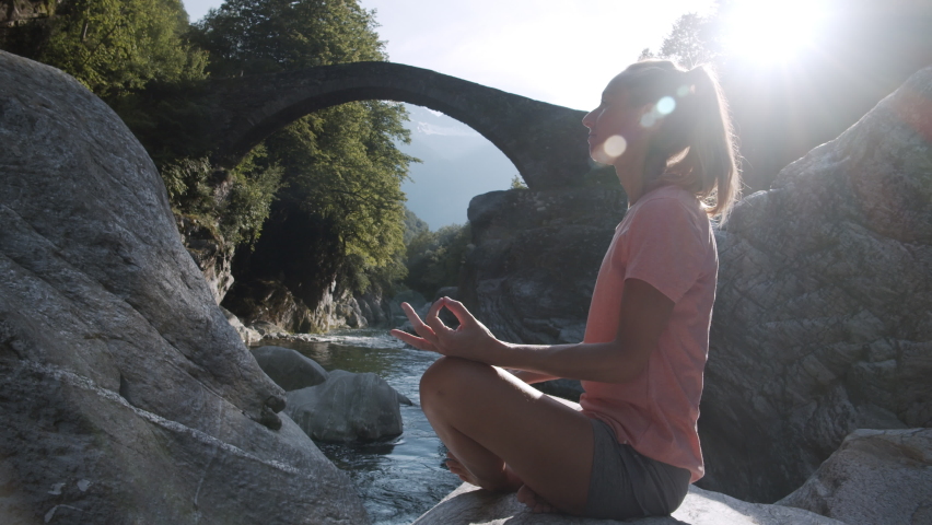 Young woman practicing meditation techniques in nature. Zen yoga meditation practice in nature. Slow motion  | Shutterstock HD Video #1062601681