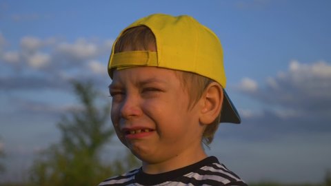 Kid is crying. close-up of a child face in tears. Domestic violence concept. Kid with tears in his eyes. Child Violence in the Family. Family concept. Kid crying, tears on his face