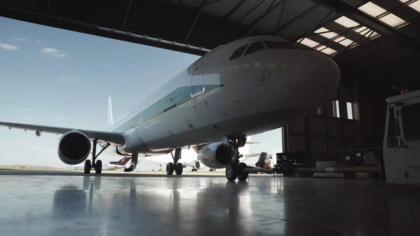 Jet being pushed out of hanger Royalty-Free Stock Footage #1062612598