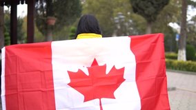 Girl holding flag of canada