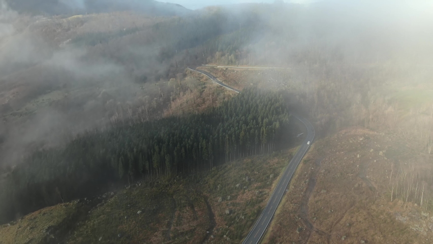 Flying Above Rural Countryside Road and Clouds in Mountainous Region of Norway. Light Traffic and Picturesque Landscape, Drone Aerial View
