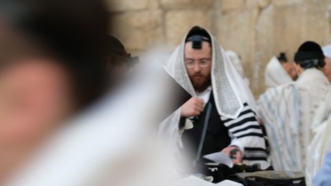 A group of Orthodox Jews praying together at the Wailing Wall, a 4K video clip 29.97 fps, December 2nd, 2018, old city of Jerusalem, Israel.