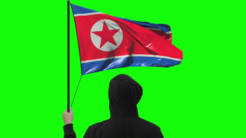Waving flag of North korea and unknown man wearing black, alpha matte