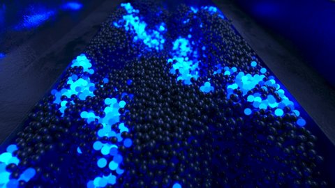Abstract cloud of randomly glowing blue spheres in a futuristic room. Conceptual technology business composition. 3d animation