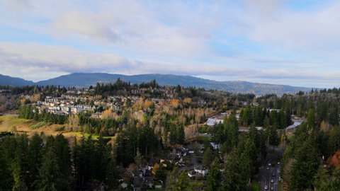 Drone / Aerial view of Residential Areas, Suburbs, Lakes and Parks with Dramatic Blue Sky and Clouds, Autumn Colors near Issaquah