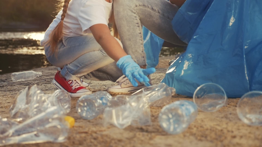 kids collecting trash volunteer a teamwork. child group happy family on collects garbage plastic trash waste bottles. environmental happy family teamwork ecology volunteer awareness trash pollution